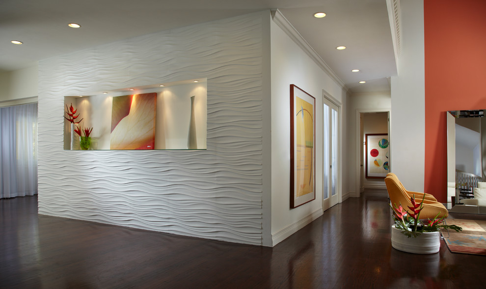 Photo of an expansive contemporary hallway in Miami with white walls, dark hardwood floors and brown floor.
