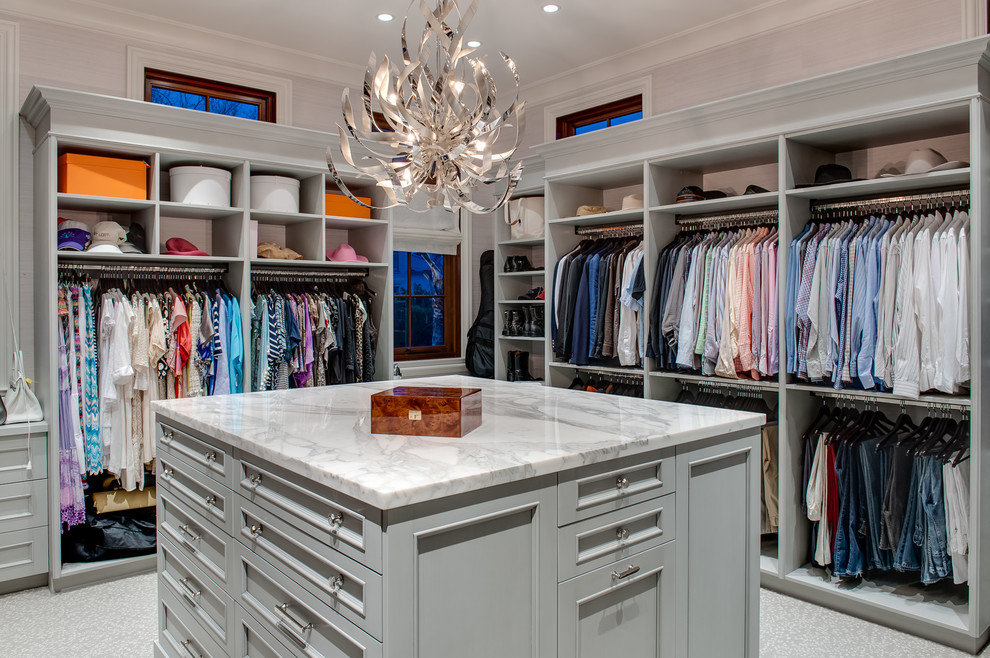 Inspiration for a large transitional gender-neutral walk-in wardrobe in Miami with grey cabinets, carpet, open cabinets and grey floor.