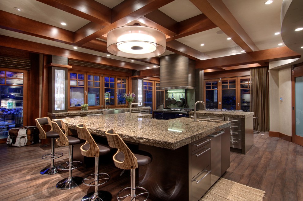 Enclosed kitchen - mid-sized transitional u-shaped dark wood floor enclosed kitchen idea in Calgary with a farmhouse sink, flat-panel cabinets, dark wood cabinets, granite countertops, stainless steel appliances and an island