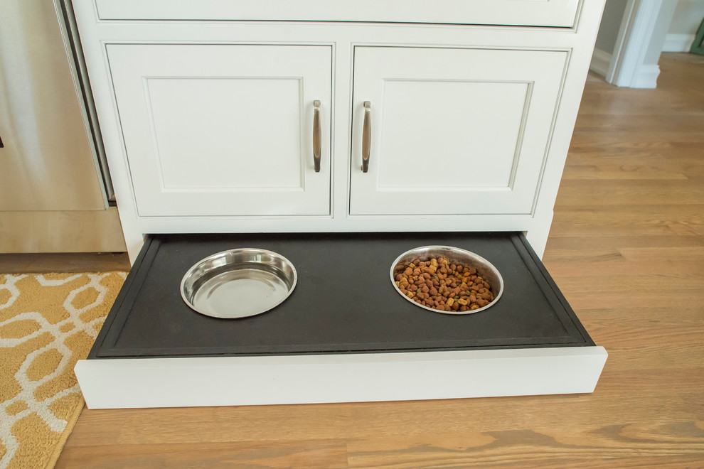 Inspiration for a timeless galley light wood floor home design remodel with an undermount sink, beaded inset cabinets, white cabinets, quartzite countertops, white backsplash, subway tile backsplash, stainless steel appliances and a peninsula