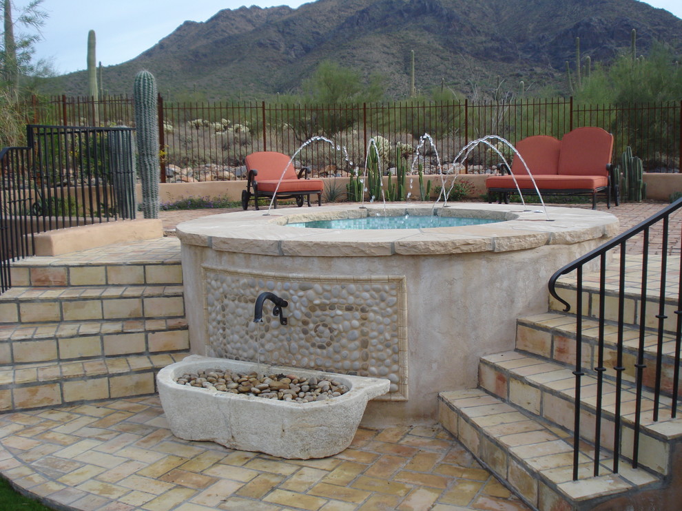 Photo of a small mediterranean backyard rectangular lap pool in Phoenix with a hot tub and tile.