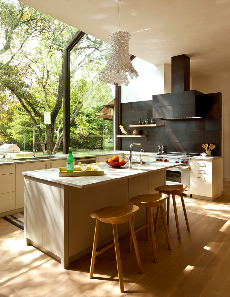 Photo of a contemporary kitchen in Austin with flat-panel cabinets, beige cabinets and metal splashback.