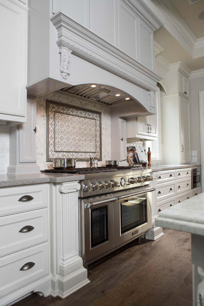 Inspiration for an expansive traditional u-shaped separate kitchen in Houston with an undermount sink, shaker cabinets, marble benchtops, stainless steel appliances, medium hardwood floors, with island, brown floor, grey benchtop and coffered.
