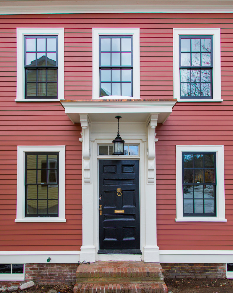 Photo of a mid-sized traditional entryway in Boston with a single front door, a black front door and red walls.