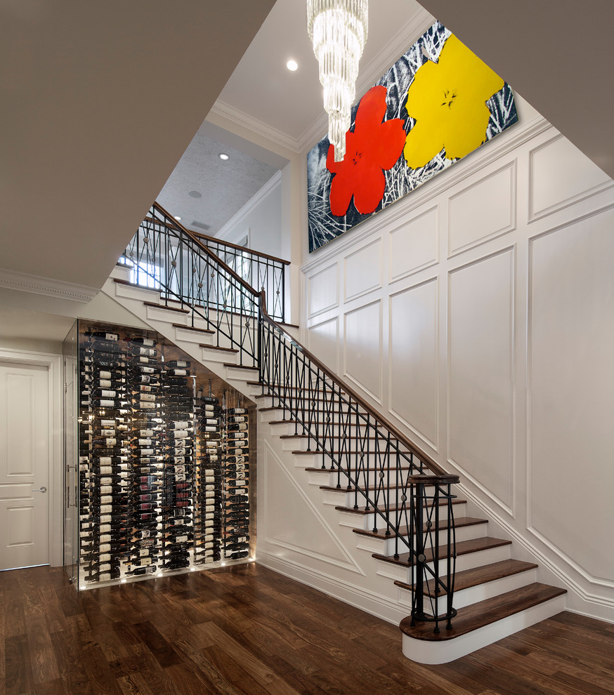 Inspiration for a mid-sized transitional wine cellar in Los Angeles with display racks and dark hardwood floors.