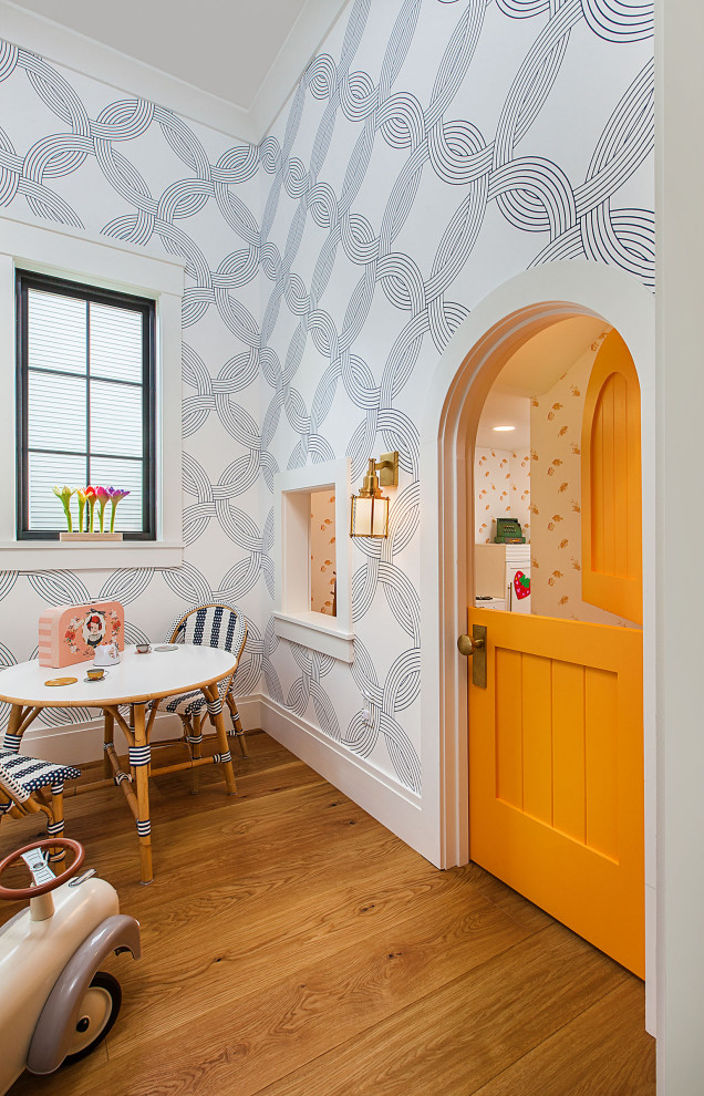 Inspiration for a large coastal gender-neutral medium tone wood floor and wallpaper playroom remodel in Detroit with white walls