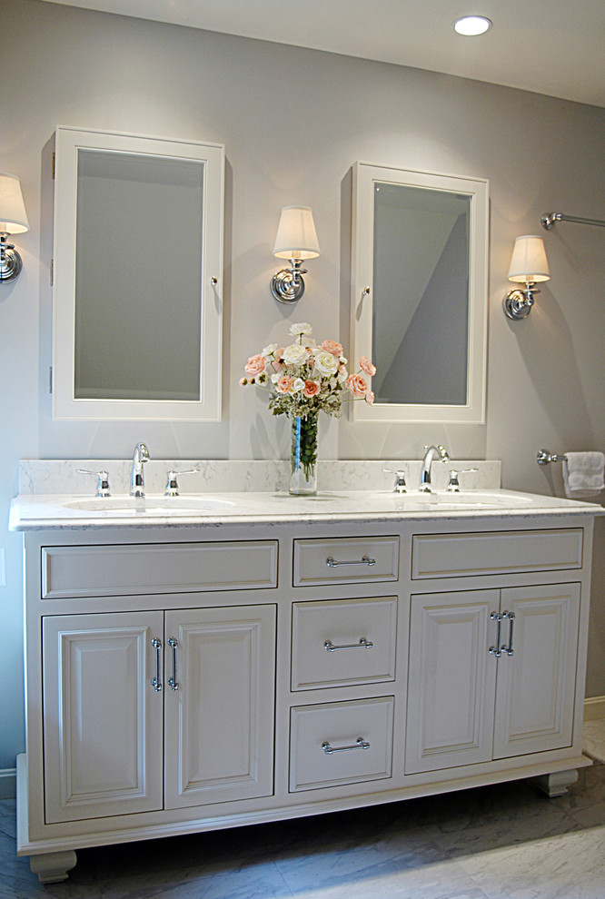 Design ideas for a mid-sized traditional master bathroom in Portland Maine with recessed-panel cabinets, white cabinets, grey walls, marble floors, an undermount sink and marble benchtops.