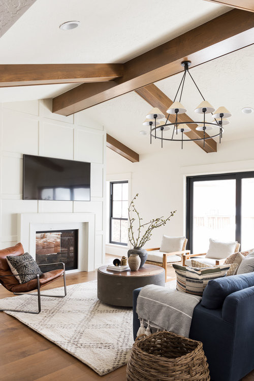 Inspiration for a large transitional open concept medium tone wood floor and brown floor family room remodel in Salt Lake City with white walls, a two-sided fireplace and a wall-mounted tv