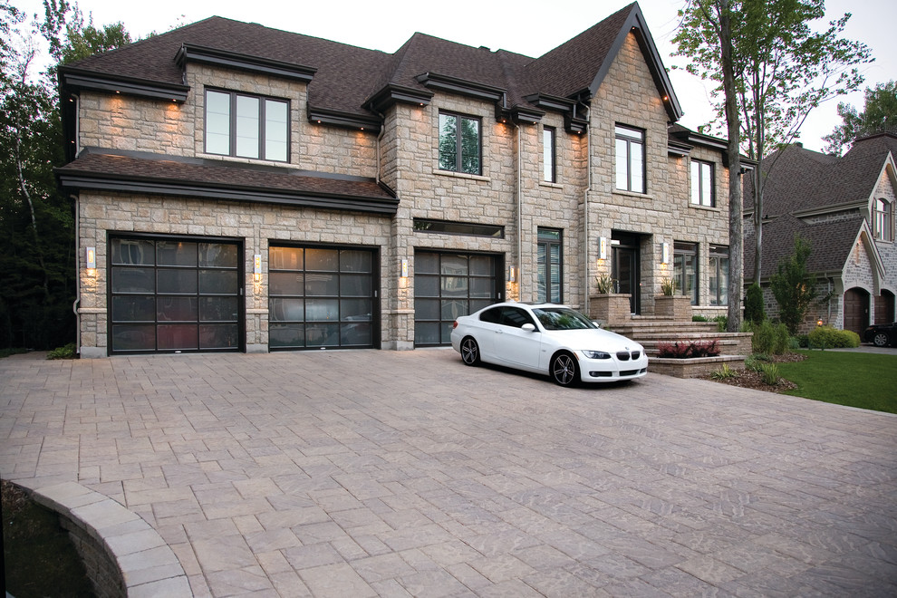 Inspiration for a large traditional two-storey beige exterior in Newark with stone veneer and a gable roof.