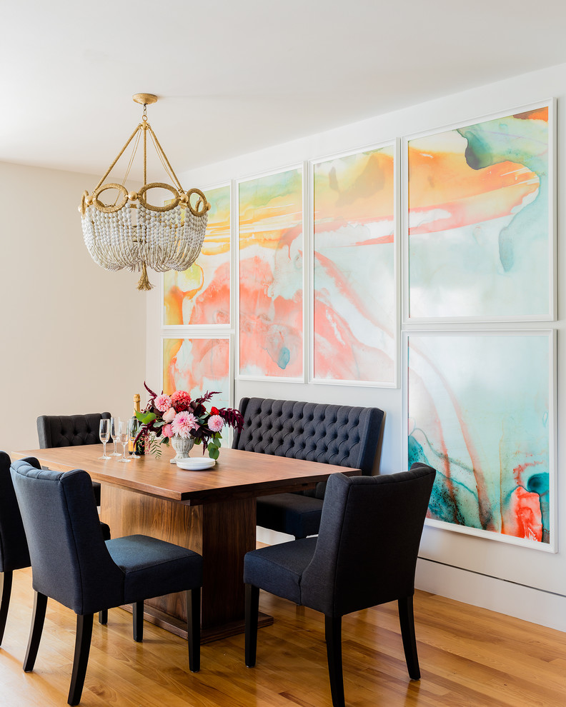 Example of a transitional light wood floor enclosed dining room design in Boston with white walls