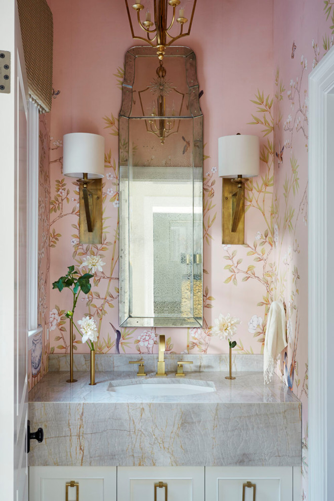 Photo of a small transitional bathroom in Other with white cabinets, a freestanding tub, pink walls, grey benchtops, a single vanity, a built-in vanity and wallpaper.