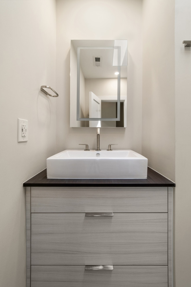 Photo of a small modern kids bathroom in DC Metro with flat-panel cabinets, an alcove shower, a two-piece toilet, cement tile, cement tiles, a vessel sink, quartzite benchtops, a hinged shower door, a shower seat, a single vanity and a built-in vanity.