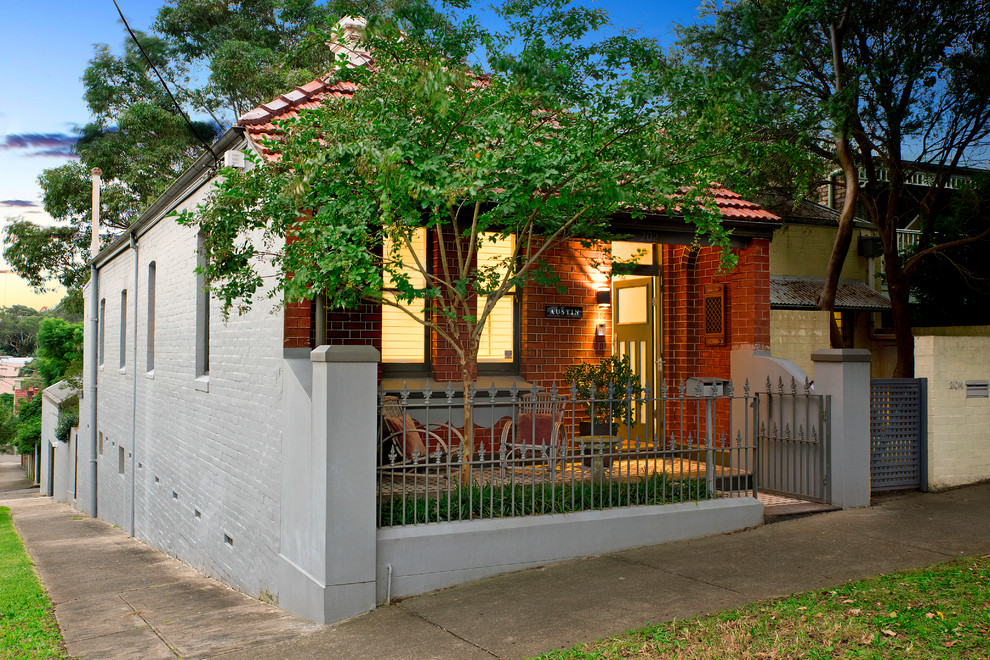 Photo of a midcentury one-storey brick brown exterior in Sydney with a gable roof.