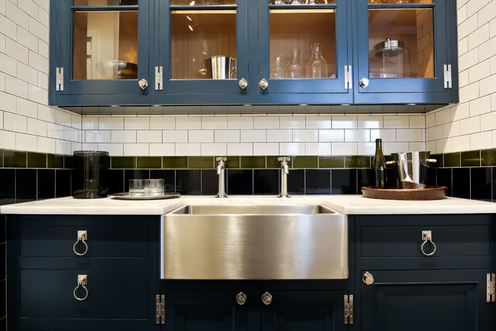 This is an example of a large traditional open plan kitchen in London with multi-coloured splashback and ceramic splashback.