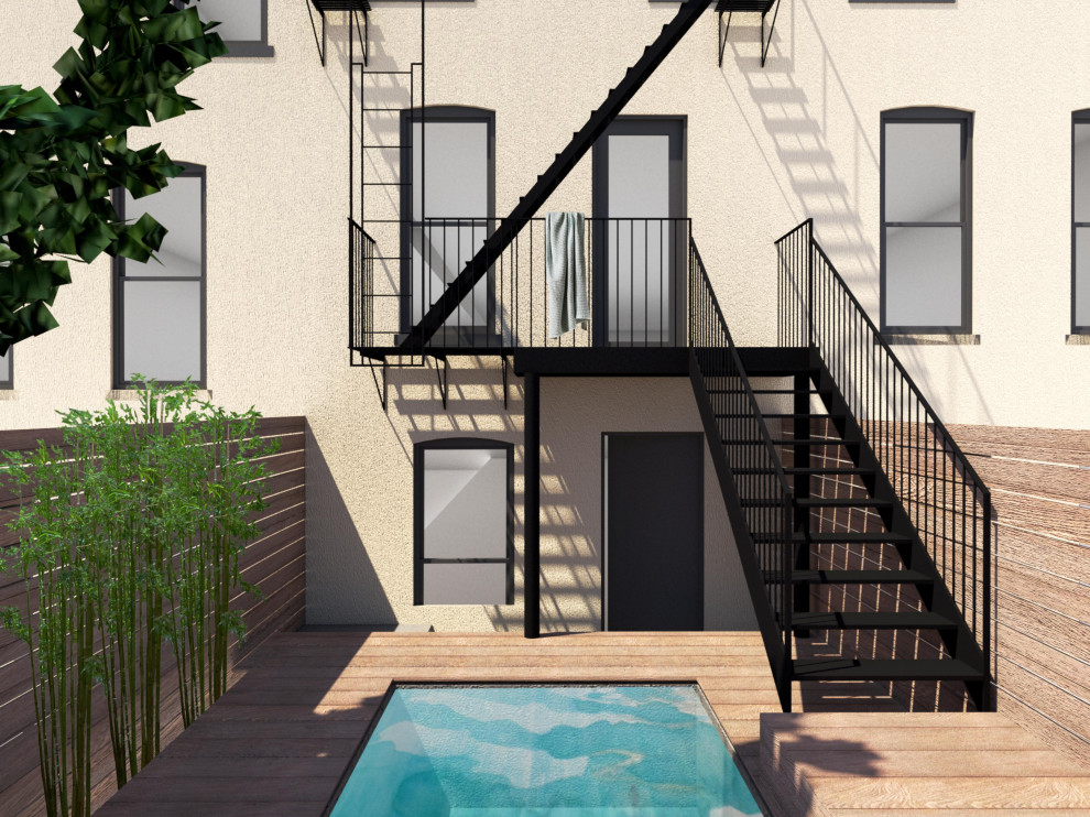 Design ideas for a small modern backyard and ground level deck in New York with metal railing.