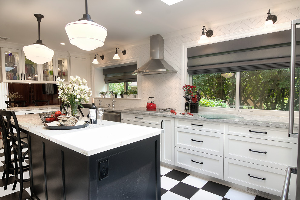 Example of a transitional u-shaped multicolored floor enclosed kitchen design with a farmhouse sink, recessed-panel cabinets, white cabinets, granite countertops, white backsplash, subway tile backsplash, stainless steel appliances, an island and beige countertops