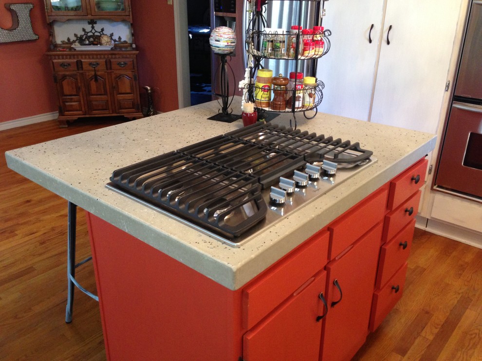 Photo of a mid-sized eclectic kitchen in Austin with flat-panel cabinets, red cabinets and laminate benchtops.