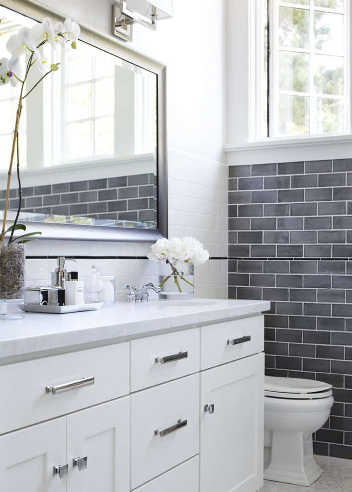 Inspiration for a transitional bathroom in San Francisco with shaker cabinets, white cabinets, gray tile, subway tile, an undermount sink and marble benchtops.