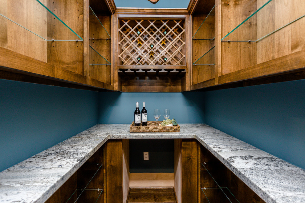 This is an example of a large contemporary wine cellar in Houston with dark hardwood floors, diamond bins and brown floor.
