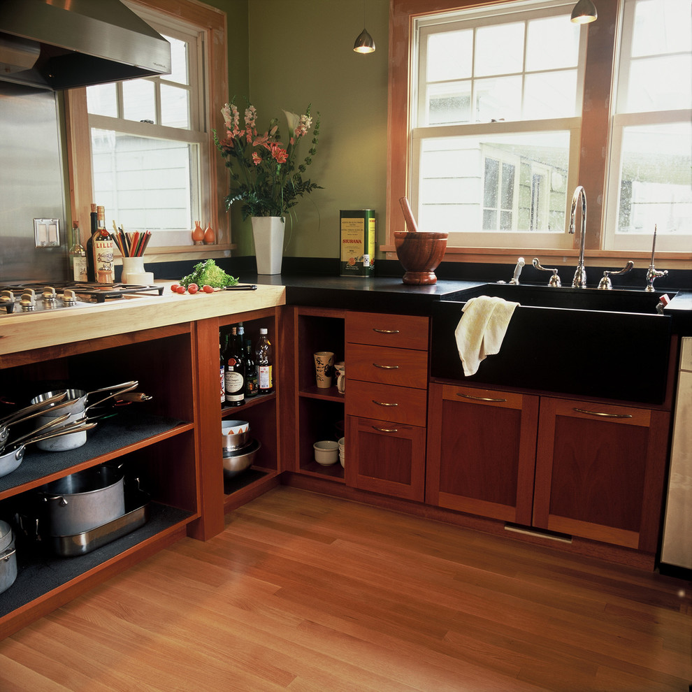 This is an example of a contemporary kitchen in Portland with a farmhouse sink, open cabinets and dark wood cabinets.