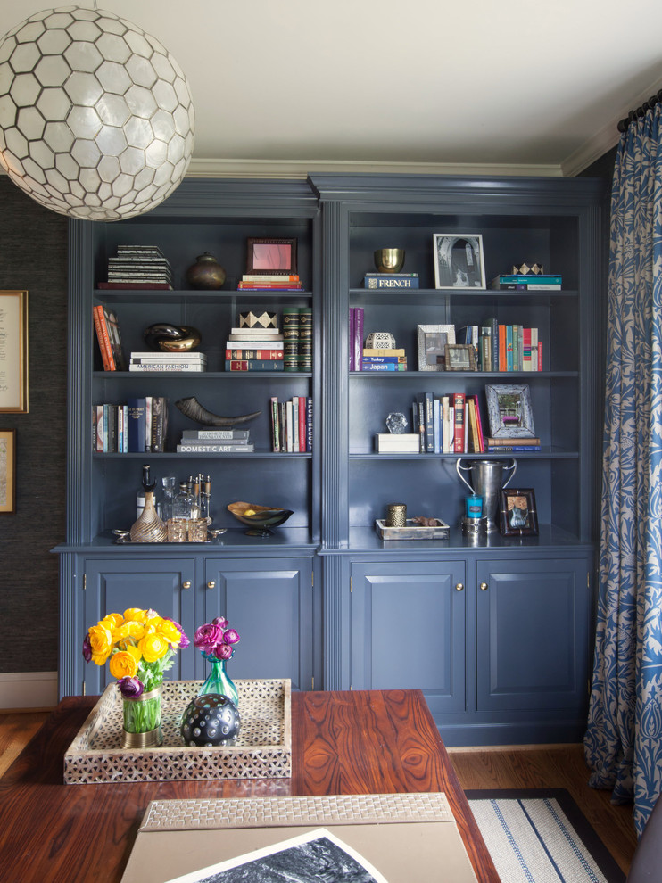 This is an example of a traditional home office in Baltimore with blue walls and a freestanding desk.