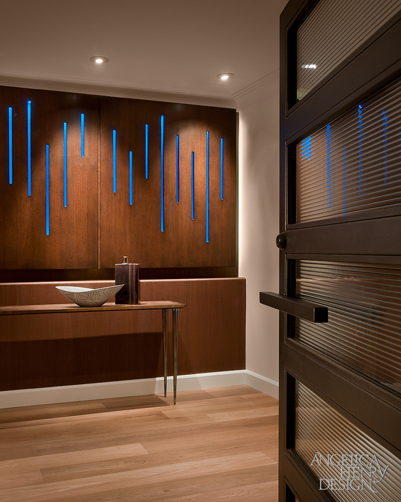 Minimalist light wood floor foyer photo in Phoenix with beige walls and a glass front door