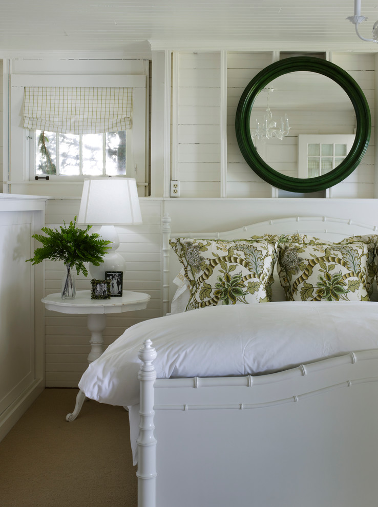 Photo of a beach style bedroom in Chicago with white walls and carpet.