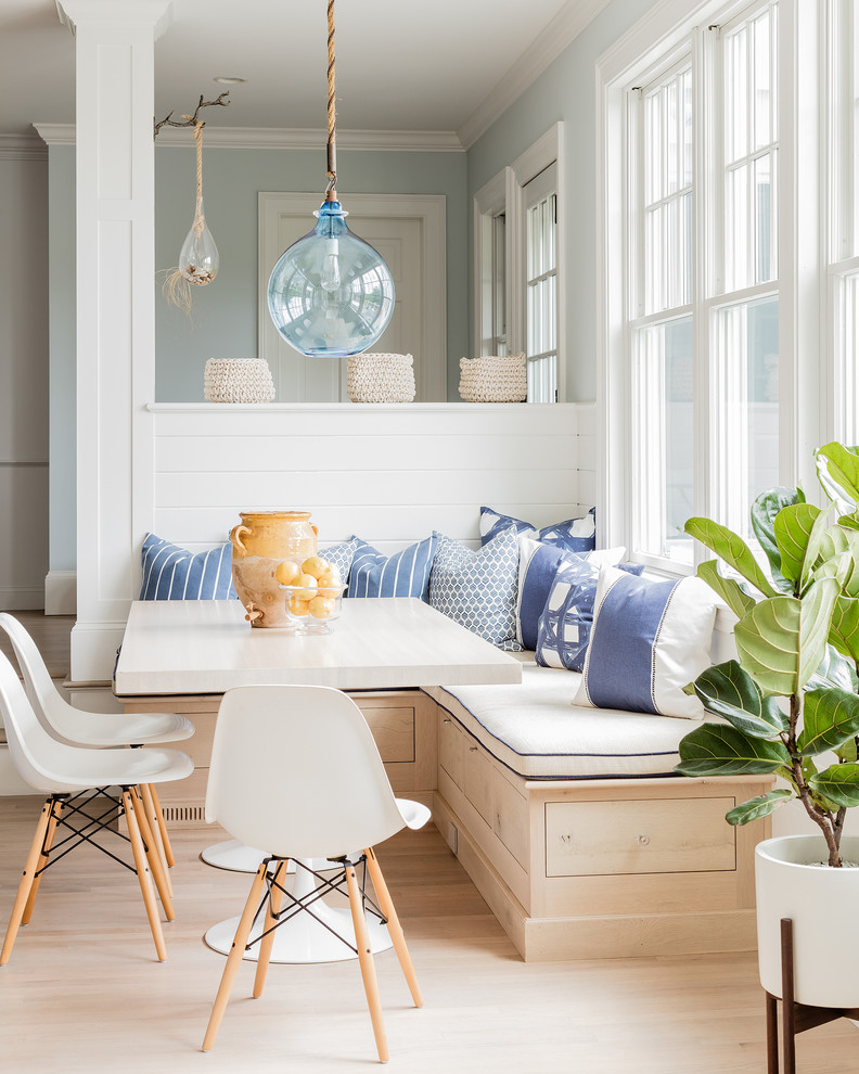 Beach style open plan dining in Boston with blue walls, light hardwood floors and planked wall panelling.