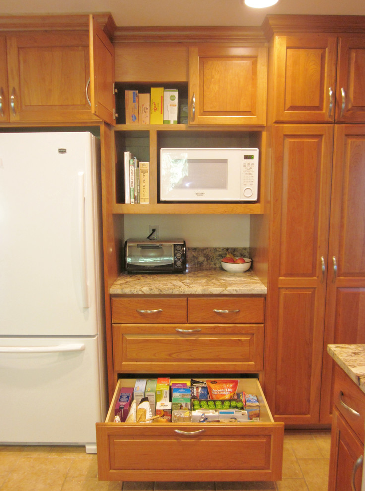 Large transitional u-shaped ceramic tile enclosed kitchen photo in Seattle with a single-bowl sink, raised-panel cabinets, medium tone wood cabinets, granite countertops, multicolored backsplash, stone slab backsplash, white appliances and two islands
