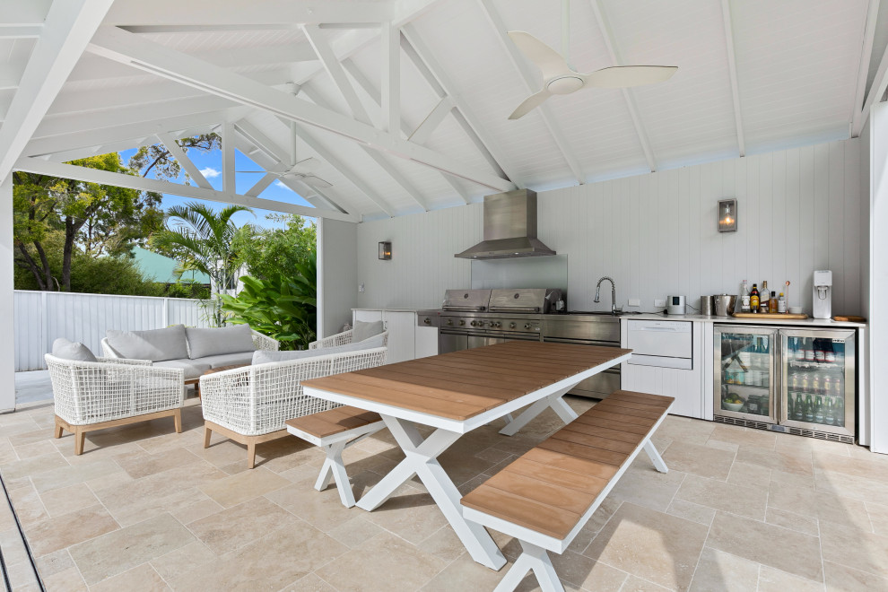 Photo of a beach style patio in Brisbane with an outdoor kitchen and tile.