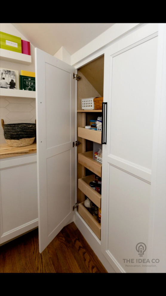 Example of a mid-sized transitional galley light wood floor and brown floor kitchen pantry design with a single-bowl sink, recessed-panel cabinets, white cabinets, quartzite countertops, multicolored backsplash, ceramic backsplash, stainless steel appliances, an island and white countertops