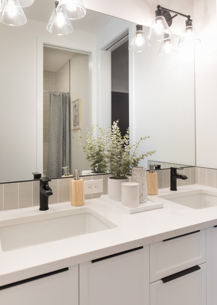 This is an example of a small classic family bathroom in Calgary with shaker cabinets, white cabinets, a freestanding bath, all types of shower, all types of toilet, green tiles, ceramic tiles, white walls, porcelain flooring, a submerged sink, solid surface worktops, grey floors, a shower curtain, white worktops, double sinks and a built in vanity unit.
