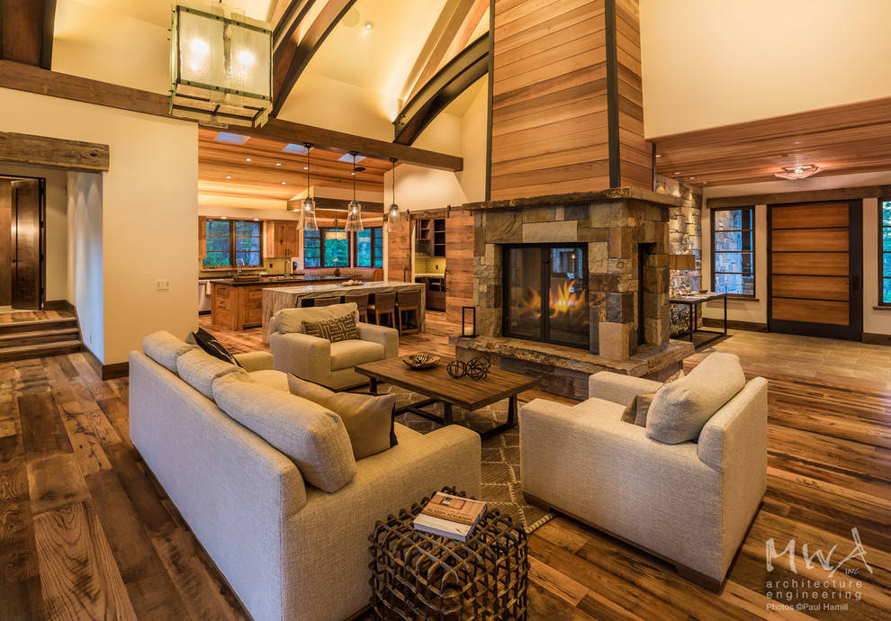 Photo of a large contemporary formal open concept living room in Other with beige walls, dark hardwood floors, a stone fireplace surround, no tv, a two-sided fireplace and brown floor.