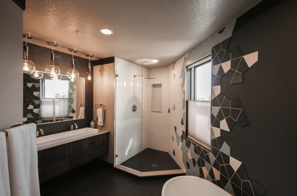 Photo of a mid-sized modern master bathroom in Denver with flat-panel cabinets, dark wood cabinets, a freestanding tub, an open shower, a two-piece toilet, multi-coloured tile, porcelain tile, black walls, slate floors, a vessel sink, engineered quartz benchtops, black floor, an open shower and grey benchtops.