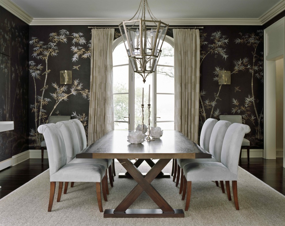 This is an example of a traditional separate dining room in New York with dark hardwood floors and black walls.