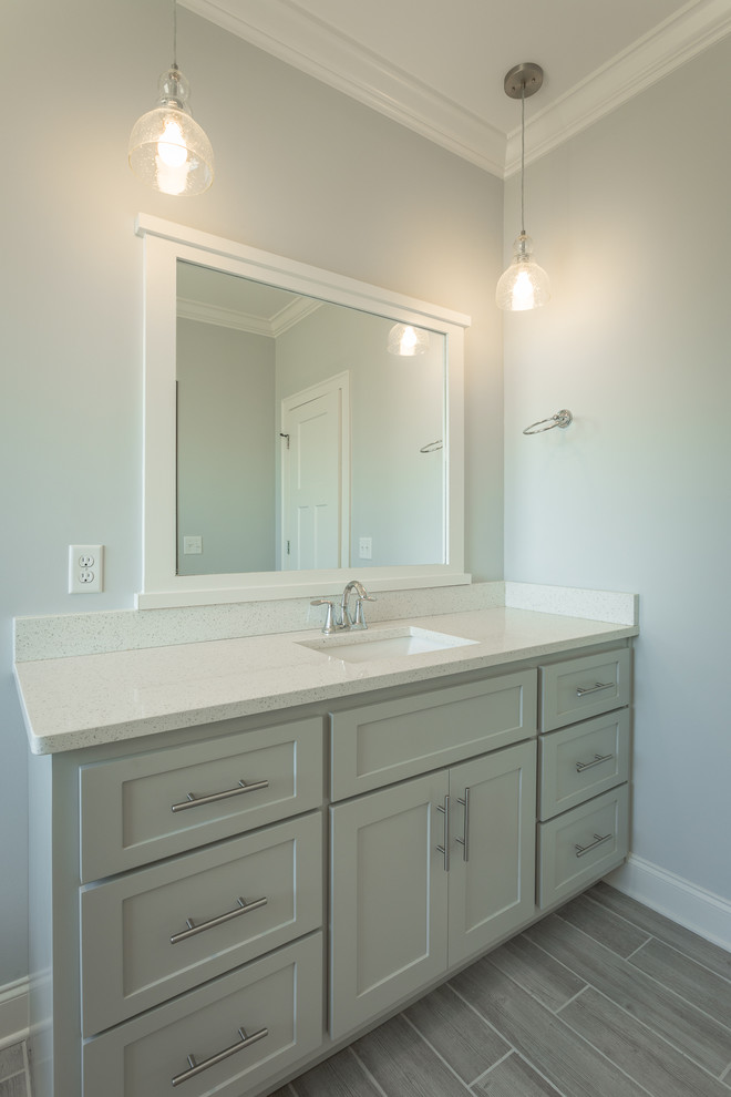 Mid-sized arts and crafts master wet room bathroom in Other with shaker cabinets, grey cabinets, a freestanding tub, gray tile, ceramic tile, grey walls, ceramic floors, an undermount sink, quartzite benchtops, grey floor and a hinged shower door.