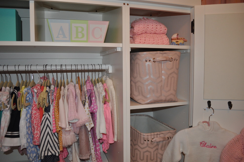 Design ideas for a mid-sized traditional nursery for girls in New York with beige walls and light hardwood floors.