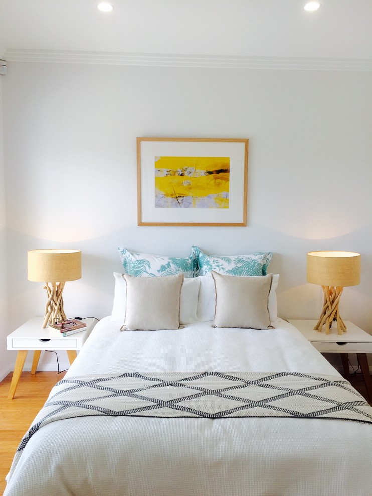 Design ideas for a contemporary bedroom in Sydney with white walls and light hardwood floors.
