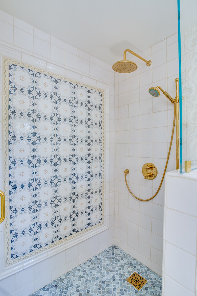 Design ideas for a mid-sized traditional master bathroom in Orange County with blue cabinets, a double vanity, a built-in vanity, wallpaper, recessed-panel cabinets, a corner shower, blue tile, ceramic tile, yellow walls, mosaic tile floors, marble benchtops, blue floor, a hinged shower door and white benchtops.