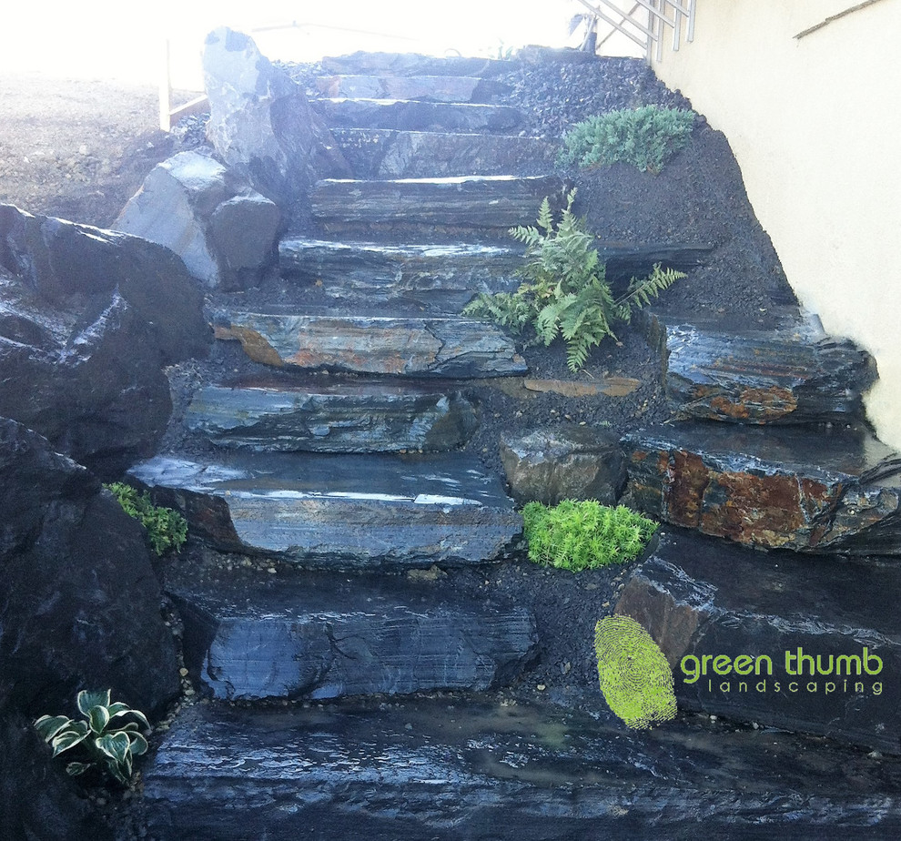 Photo of a mid-sized rustic partial sun side yard stone retaining wall landscape in Edmonton for summer.