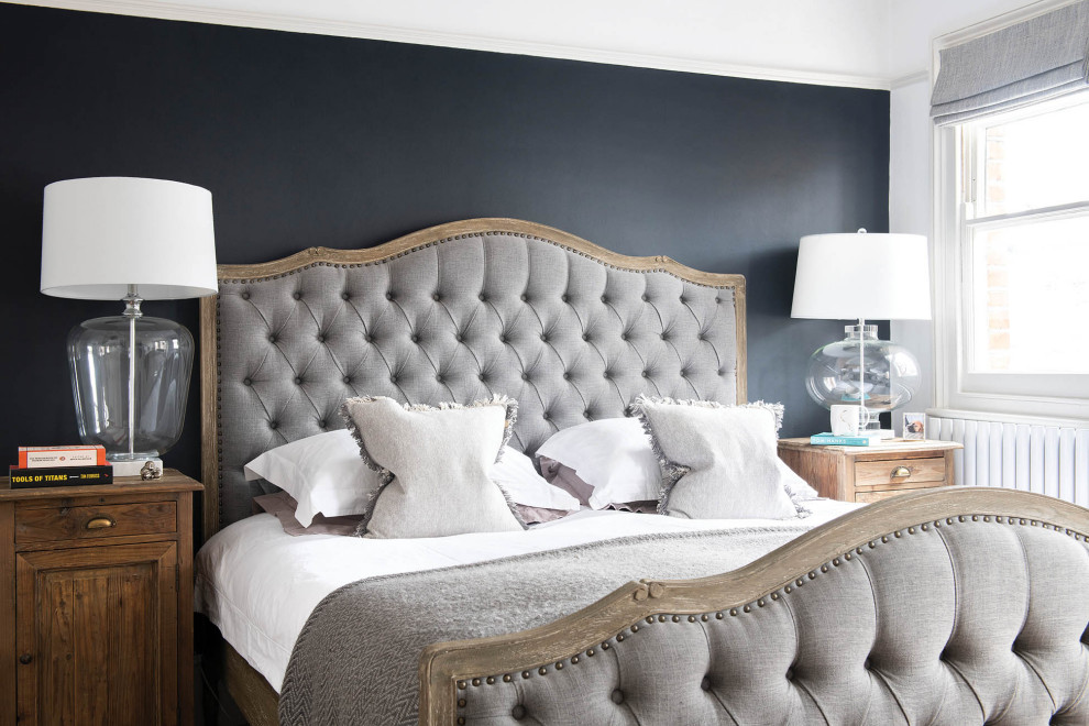 Inspiration for a mid-sized traditional master bedroom in London with black walls.
