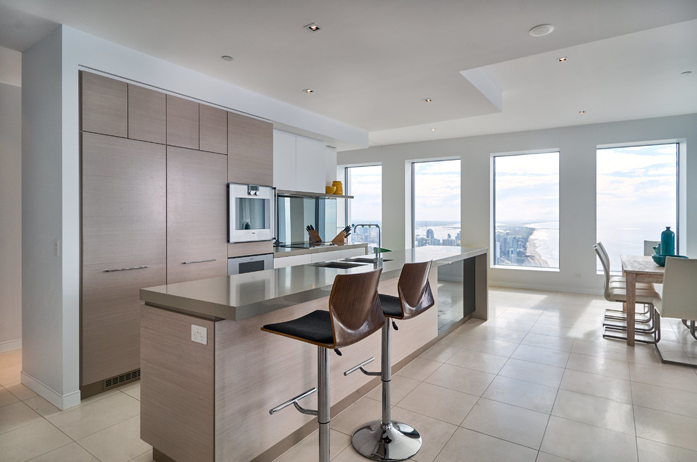 This is an example of a contemporary eat-in kitchen in Christchurch with a double-bowl sink, flat-panel cabinets, light wood cabinets, stainless steel appliances and with island.