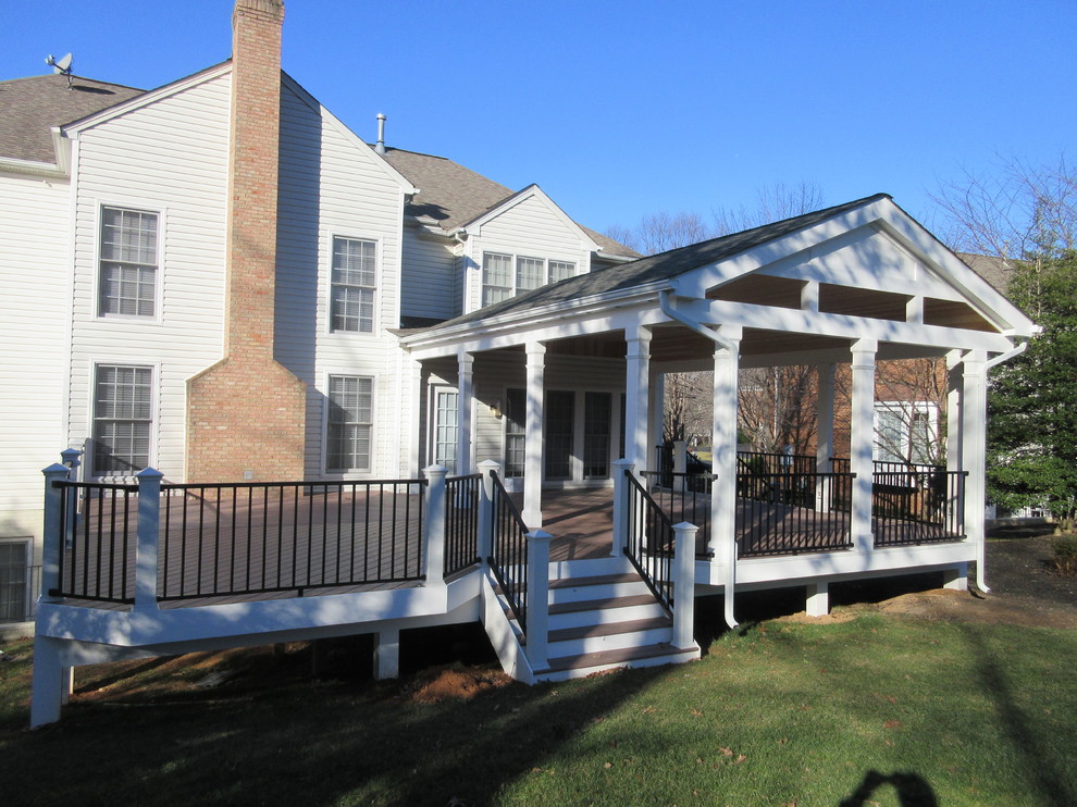 This is an example of an expansive traditional backyard verandah in DC Metro with a roof extension.