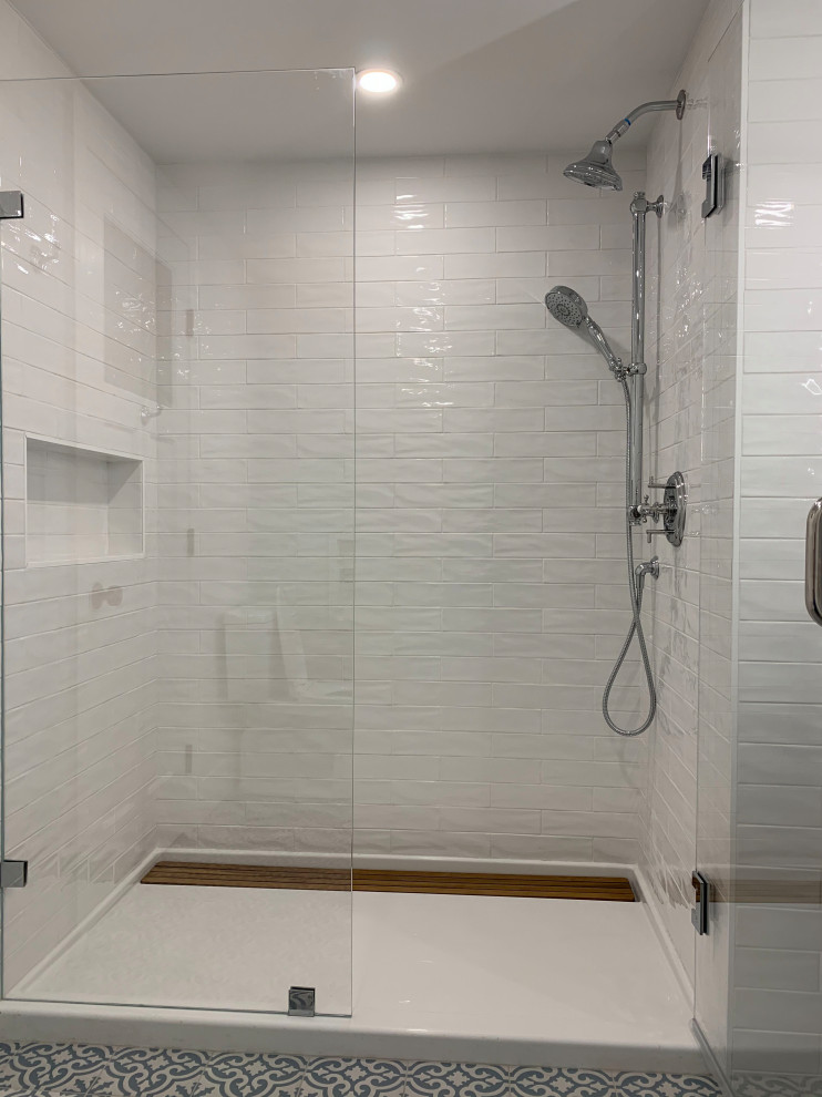 Inspiration for a mid-sized transitional 3/4 bathroom in Boston with shaker cabinets, grey cabinets, an alcove shower, white tile, subway tile, an undermount sink, engineered quartz benchtops, a hinged shower door and grey benchtops.