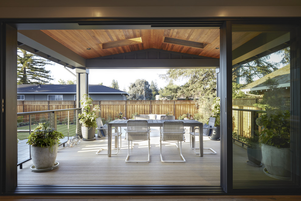 This is an example of a large arts and crafts backyard deck in San Francisco with an awning.