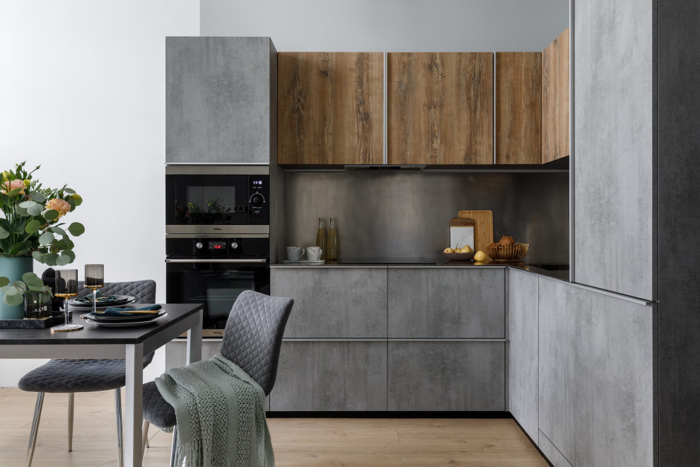 Design ideas for a small contemporary l-shaped eat-in kitchen in Moscow with a single-bowl sink, grey cabinets, stainless steel benchtops, grey splashback, panelled appliances, no island and grey benchtop.