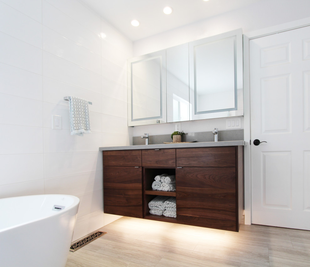 Freestanding bathtub - large transitional master white tile and ceramic tile porcelain tile, gray floor and double-sink freestanding bathtub idea with flat-panel cabinets, dark wood cabinets, a one-piece toilet, white walls, an undermount sink, quartz countertops, gray countertops, a niche and a floating vanity