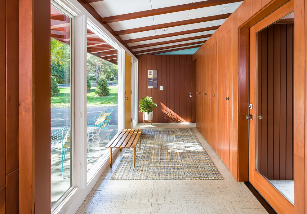 This is an example of a midcentury entryway in Minneapolis with a single front door and a yellow front door.
