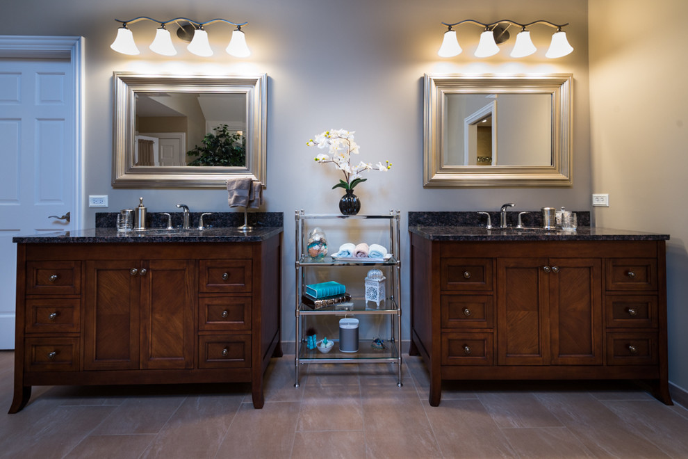 Inspiration for a large transitional master bathroom in Chicago with an undermount sink, furniture-like cabinets, dark wood cabinets, granite benchtops, a claw-foot tub, a double shower, a two-piece toilet, beige tile, porcelain tile, beige walls and porcelain floors.