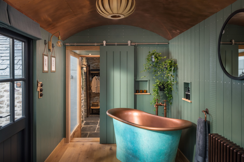 Inspiration for a medium sized rural shower room bathroom in Cornwall with a freestanding bath, a walk-in shower, a one-piece toilet, beige tiles, stone tiles, beige walls, medium hardwood flooring, wooden worktops, brown floors, an open shower and double sinks.